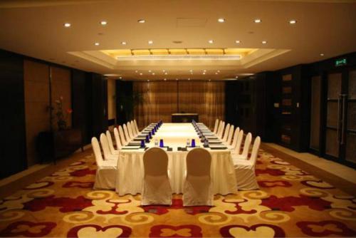 a large meeting room with a long table and chairs at V-Continent Beijing Parkview Wuzhou Hotel in Beijing