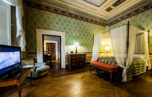 a bedroom with a bed and a flat screen tv at Palazzo Rocchi - Residenza D'Epoca in Lucca