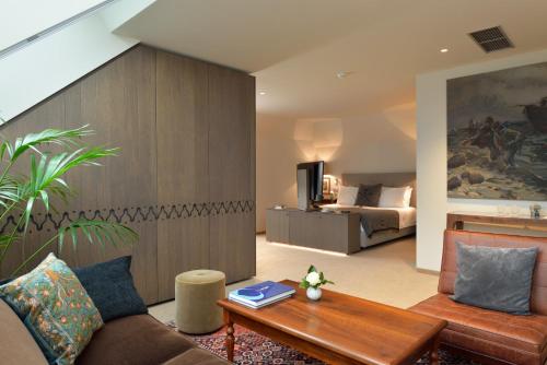 a living room with a couch and a bed at King's and Lake's House Golf Course Royal Bled in Bled