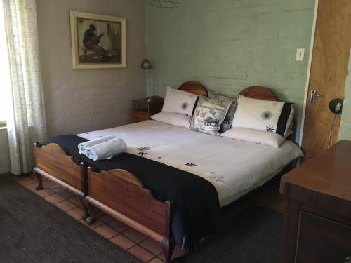 a bedroom with a large bed with pillows on it at White Bridge Farm Accommodation in Wolseley