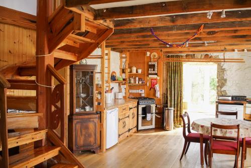 a kitchen with wooden walls and a table and chairs at No3 Luib in Luib