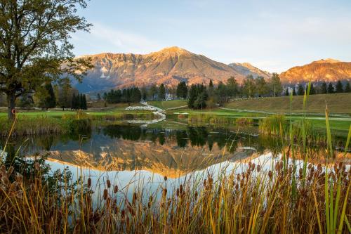 a view of a lake with a mountain in the background at King's and Lake's House Golf Course Royal Bled in Bled