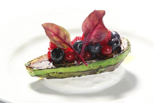 a dessert with fruit on a white plate at King's and Lake's House Golf Course Royal Bled in Bled