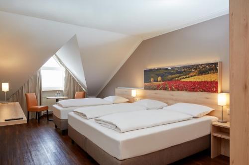 Posteľ alebo postele v izbe v ubytovaní H+ Hotel Stuttgart Herrenberg