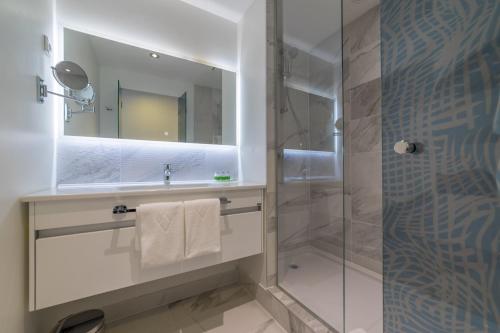 シベニクにあるAmadria Park Family Hotel Jakovのバスルーム(シャワー、シンク、鏡付)