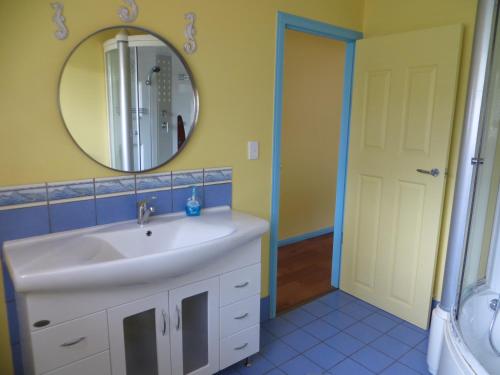 a bathroom with a sink and a mirror at Orchid Beach Retreat Orchid Beach Fraser Island in K'gari Island (Fraser Island)