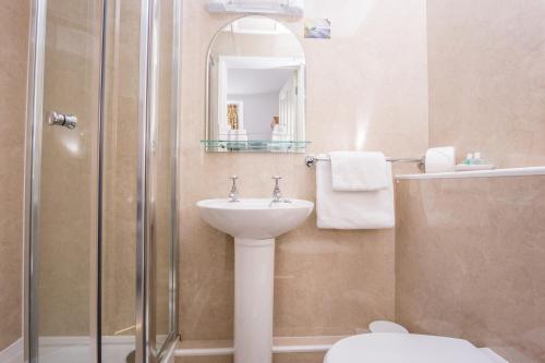 a bathroom with a sink and a shower at The Queens Hotel in Penzance