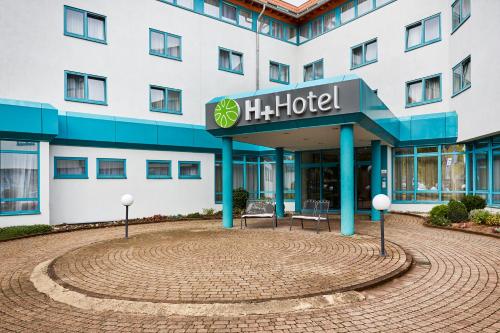 a hotel in front of a building at H+ Hotel Stuttgart Herrenberg in Herrenberg