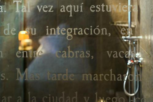 a reflection of a person in a bathroom mirror at Hotel La Casueña in Lanuza