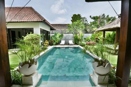 a swimming pool in the backyard of a villa at Katala Suites and Villas in Sanur