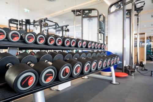 a row of rows of dumbbells in a gym at Posthotel Achenkirch Resort and Spa - Adults Only in Achenkirch