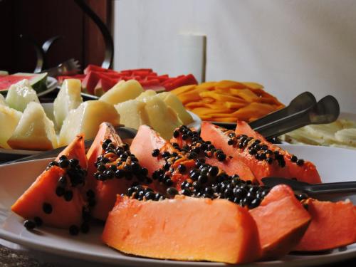 a plate full of different types of food on a table at Pousada Araujo Bazilio in Tiradentes