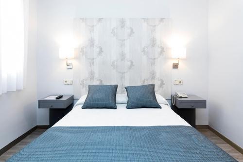 Postel nebo postele na pokoji v ubytování Hostal Oriente
