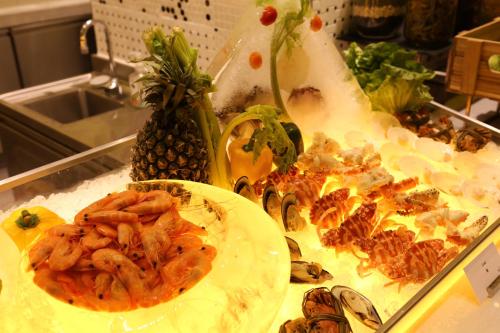 a buffet with shrimp and other food on a table at Hard Rock Hotel Shenzhen in Shenzhen