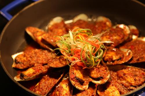 a pan filled with food with meat and sauce at Hard Rock Hotel Shenzhen in Shenzhen