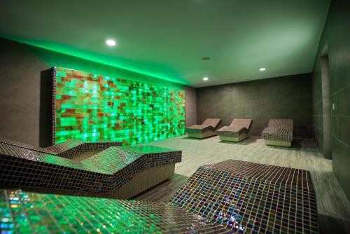 a room with chairs and a wall with green lights at Kn Hotel Matas Blancas - Solo Adultos in Costa Calma