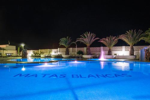 a large swimming pool at night with a fountain at Kn Hotel Matas Blancas - Solo Adultos in Costa Calma