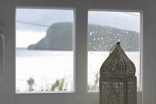 a window with a view of a snow covered field at Canário do Mar - Rural Tourism in Angra do Heroísmo
