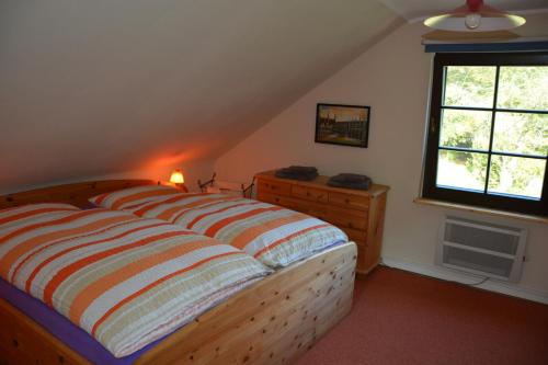 オーバーヴェーゼルにあるgemütliches kleines Ferienhausのベッドルーム(大型ベッド1台、窓付)