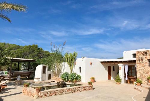 a white house with a courtyard with a fountain at Villa Sa Paissa in Cala Vadella