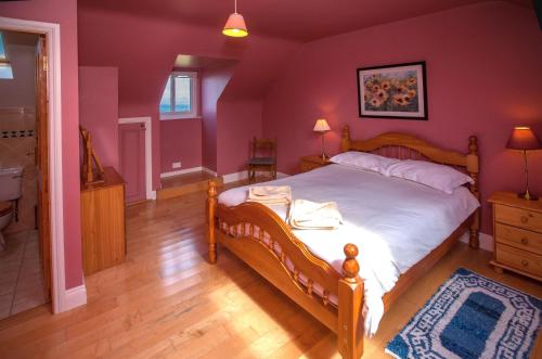 倫維爾的住宿－Cottage 259 - Renvyle，一间卧室配有一张床和紫色的墙壁