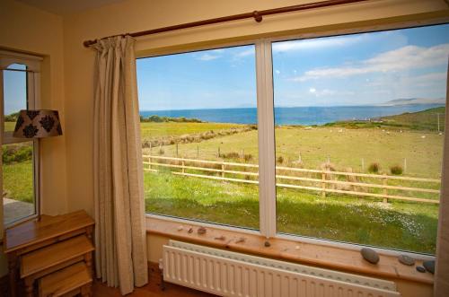 a window in a room with a view of a field at Cottage 259 - Renvyle in Renvyle