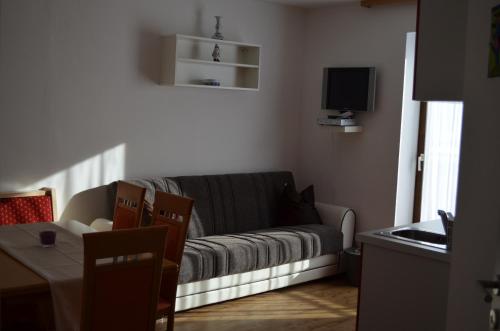 a living room with a couch and a table at Haus Garten An der Sonne in Niedernsill