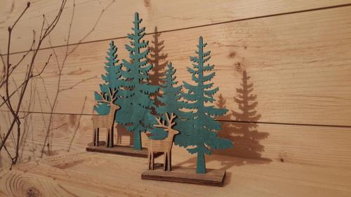 a painting of pine trees and a chair on a wall at Alpenchalet Vils Tirol in Vils