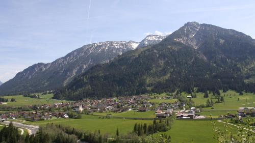 a village in a valley with mountains in the background at Alpenchalet Vils Tirol in Vils