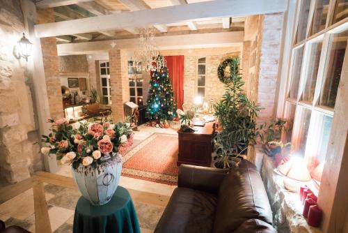 a living room with a christmas tree and a vase of flowers at Vila Terrasse in Košice