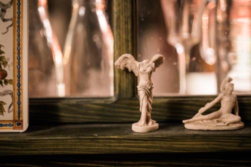 two miniature angel figurines sitting on a table at Vila Terrasse in Košice