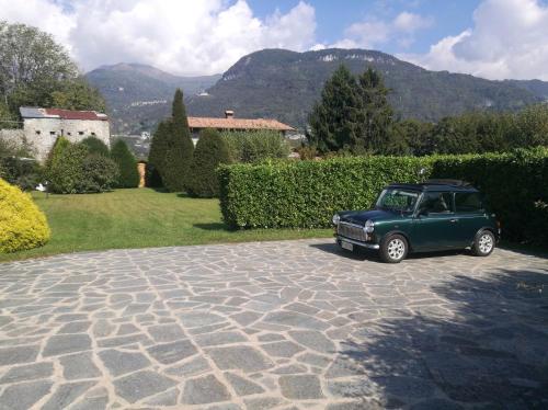 a green car parked on a stone driveway at Casa Cinzia in Gravedona