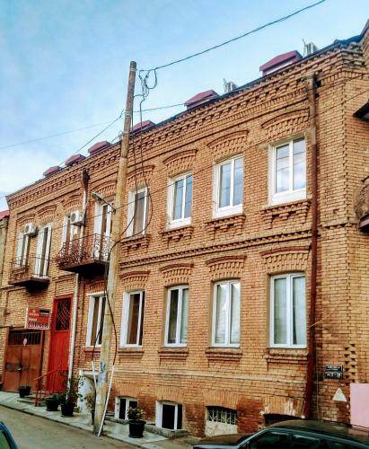 a large brick building on a city street at Hotel Corner in Tbilisi City