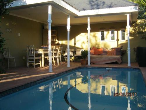 a swimming pool in front of a house at Roche House in Queenstown