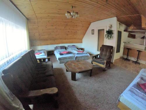 a living room with a couch and a table and chairs at Zajazd Tip Top in Iganie