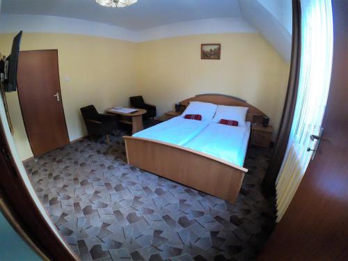 a bedroom with a bed and a desk and a table at Zajazd Tip Top in Iganie