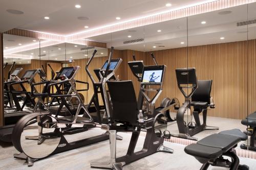 a gym with rows of exercise bikes and treadmills at Maison Bréguet in Paris