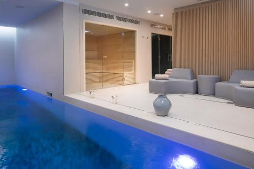 a house with a swimming pool and a living room at Maison Bréguet in Paris