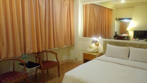 Postel nebo postele na pokoji v ubytování 苓雅大飯店 Lingyea Hotel