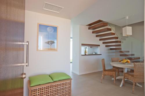 a living room with a spiral staircase and a table at Seasagres - Design Villas in Sagres