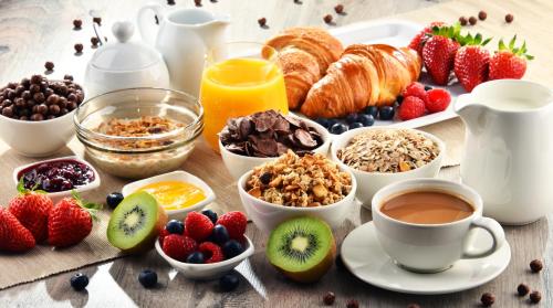 a table topped with breakfast foods and coffee and fruit at 7th Floor Suite in Naples