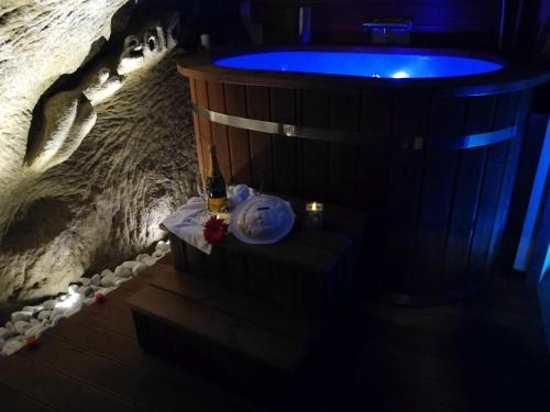 a jacuzzi tub with a bottle of beer on a table at MIRUTT Relax by Keyhole Selection in Castelmezzano