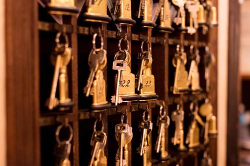a bunch of keys hanging on a wall at Hotel Flora in Venice