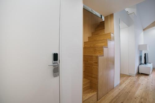 a door leading to a hallway with wooden floors at D'Autor Apartments Sá da Bandeira in Porto