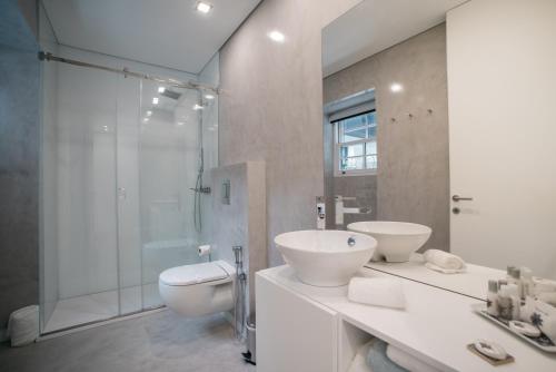 a bathroom with a toilet and a sink and a shower at D'Autor Apartments Sá da Bandeira in Porto