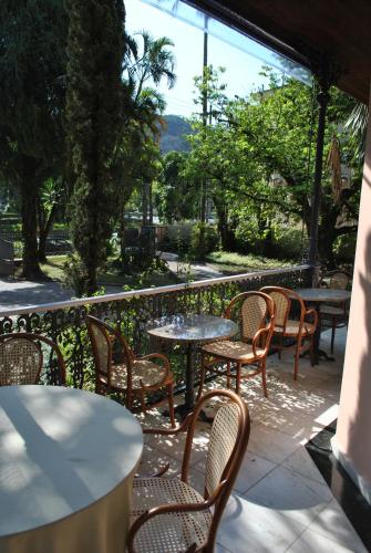 a group of tables and chairs on a patio at Hotel Casablanca Koeler in Petrópolis