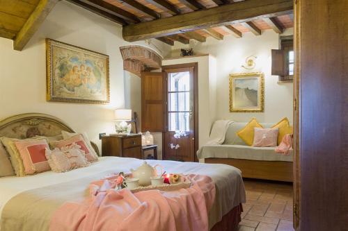 a bedroom with a bed with a doll on top of it at Mulino del XVII secolo in Borgo a Buggiano