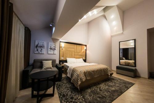 - une chambre avec un lit, une table et un canapé dans l'établissement Mon Ami Villa, à Chişinău