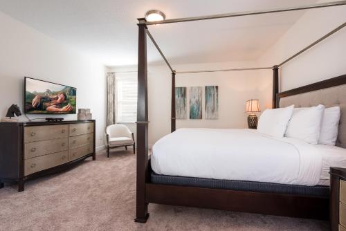 - une chambre avec un grand lit et une commode dans l'établissement Cozy Home by Rentyl Near Disney with Private Pool & Resort Amenities - 340P, à Orlando