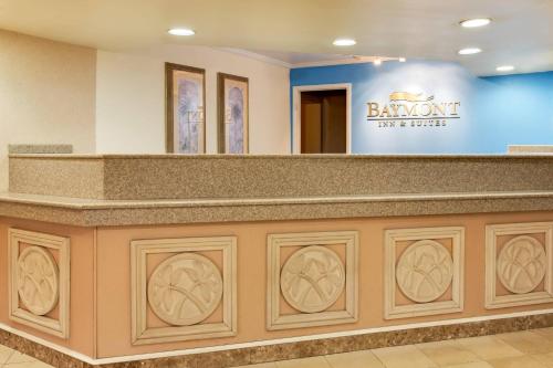 a lobby with a large counter with a sign on it at Baymont by Wyndham Lake City in Lake City